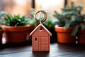 Keychain in the form of a house on the table. Mortgage, investment, real estate