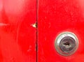 The keyhole is contrasted with the red color of the postbox.