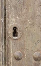 Keyhole in an old paneled wooden door; Royalty Free Stock Photo