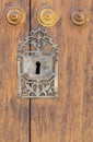 Keyhole in an old paneled wooden door; Royalty Free Stock Photo