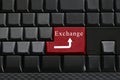 Keypad of black keyboard and have text Exchange on enter button.