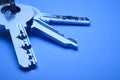 Keyring with keys in blue tone over an empty background