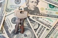 The keys on a background of money. The concept of buying or renting a home