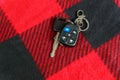 Keys from the car on the red fabric alarm system Royalty Free Stock Photo