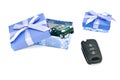 Keys, green car and blue gift boxes