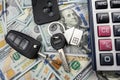 keys of house and car with calculator on us dollar money Royalty Free Stock Photo