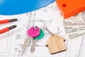 Keys with house shape, currencies dollar and electrical construction drawings with work tools. Building or buying home concept Royalty Free Stock Photo