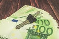 Keys lie on green banknotes with a nominee of 100 euros Royalty Free Stock Photo