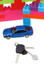 Keys, model car, plastic block house