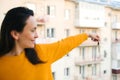 Keys from new apartment against high building. Woman holding keys to a new apartment. Real estate industry Royalty Free Stock Photo