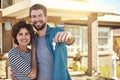 Keys, new home and portrait of a couple outdoor at a real estate property with pride for buying a house. Happy woman and Royalty Free Stock Photo