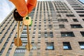 The keys to the apartment in the background of the facade of the house .