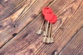 The keys to the front door of a private house or apartment lie on a wooden background Royalty Free Stock Photo