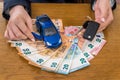 Keys and toy car on euro money, female hands Royalty Free Stock Photo