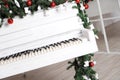 Keys on white upright piano with christmas decor Royalty Free Stock Photo