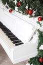 Keys on white upright piano with christmas decor Royalty Free Stock Photo