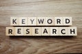 Keyword Research alphabet letter on wooden background