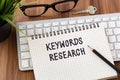 Keywords research concept with computer and key Royalty Free Stock Photo