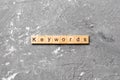 KEYWORDS word written on wood block. KEYWORDS text on cement table for your desing, concept Royalty Free Stock Photo