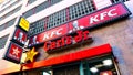 KFC Kentucky Fried Chicken and Carl`s Jr. Charbroiled Burgers signs, American fast food restaurants Royalty Free Stock Photo