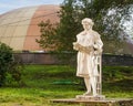 Massive traditional urban park gypsum sculpture of the times of the USSR. Girl reading a book.