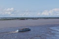 Walking excursion river ship with tourists moves along Amur River. Water level in river is higher than normal. Flooded shores are