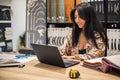 Khabarovsk, Russia, Desember 16, 2021. Happy Asian woman professional interior designer working use laptop at office Royalty Free Stock Photo