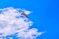 Khabarovsk, Russia - May 02, 2022: A paraglider with a red parachute flies against the blue sky. Royalty Free Stock Photo