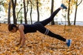 Khabarovsk, Russia - Oct 07, 2018: An attractive woman in sports clothes doing sports exercises in nature against the sunset and