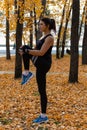 Khabarovsk, Russia - Oct 07, 2018: An attractive woman in sports clothes doing sports exercises in nature against the sunset and