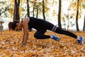 Khabarovsk, Russia - Oct 07, 2018: An attractive woman in sports clothes doing sports exercises in nature against the sunset and