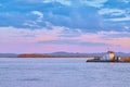 Khabarovsk, Russia - Sep 29, 2021: Sunset on the embankment of the Amur river in Khabarovsk. A barge with timber floats