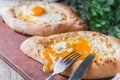 Khachapuri in Adzharian with Adyghe cheese, cheese and yolk. Traditional Caucasian food Royalty Free Stock Photo