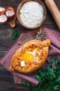 Khachapuri Ajarian on rustic wooden background