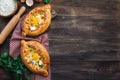 Khachapuri Ajarian on rustic wooden background