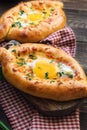 Khachapuri Ajarian on rustic wooden background