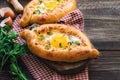 Khachapuri Ajarian on rustic wooden background