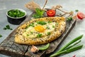 Khachapuri cheese and egg filled bread on a wooden board, top view. copy space