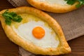 Khachapuri with eggs close-up on sacking Royalty Free Stock Photo