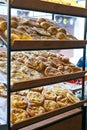 Khachapuri flatbread made from dough, cheese and bacon on wooden shelves in a bakery. Georgian traditional khachapuri at Royalty Free Stock Photo