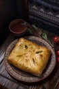 Khachapuri with meat on a wooden background