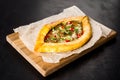 Khachapuri meat on a wooden board shot on a black background