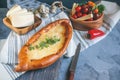 Khachapuri is a traditional Georgian cheese bread. Bread with cheese and eggs with greens