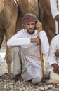 Omani man with his camels before a race