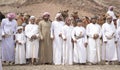 Omani men with their camels in a countryside