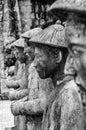 Faces of a row of statues at the Khai Dinh Emperor`s Mausoleum in Hue, Vietnam, with other statues in the background