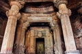 Khajuraho sculptures and paterned columns inside dark temple, India. Sacred place with artworks from 10th century Royalty Free Stock Photo