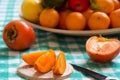 Khaki fruit slices on a table and knife Royalty Free Stock Photo