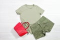 Khaki mint female t shirt mockup flat lay on wooden background. Summer clothing canas. Mint trousers. Top front view t-shirt.