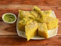 Khaman Dhokla made up of rice or urad dal is a popular breakfast or Snacks recipe from Gujarat, India, served with Green chutney Royalty Free Stock Photo